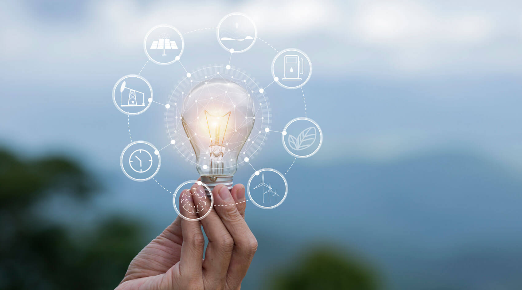 Hand holding illuminated lightbulb with smart energy technology connections