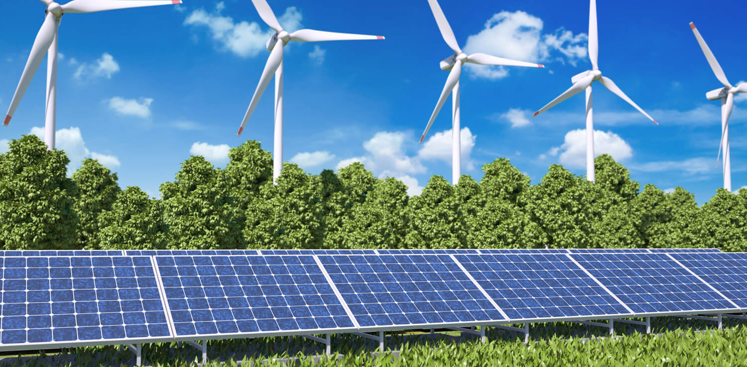 Solar panels flanked by trees and wind turbines