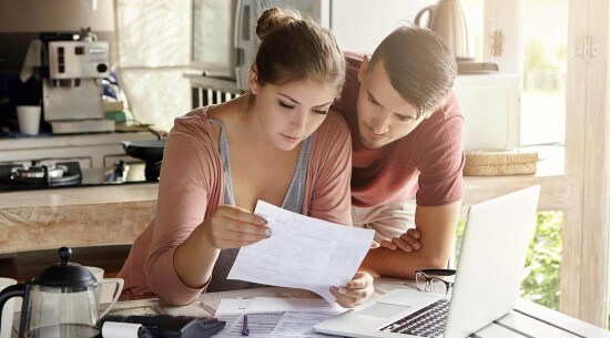 Woman and man reading bill.
