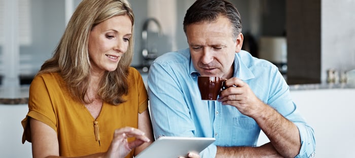 Retiring couple comparing electricity rates on ipad