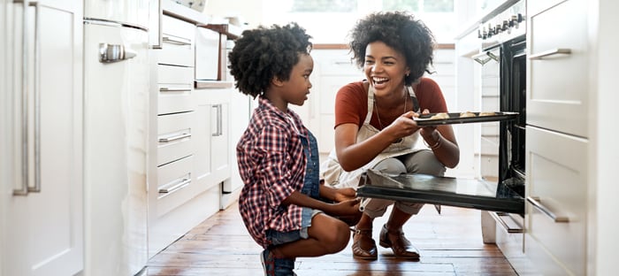 mom and child baking cookies at home