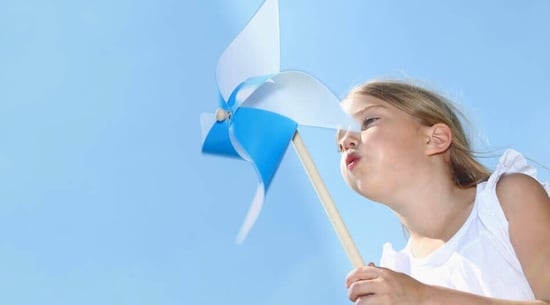 Little girl playing with pinwheel