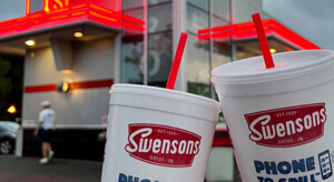 Two beverage cups with the Swensons logo.