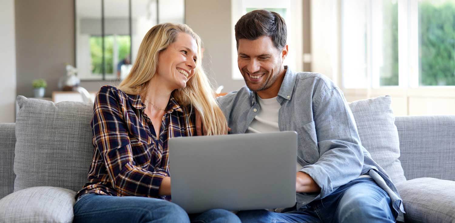 Couple finding the right electric rate on laptop