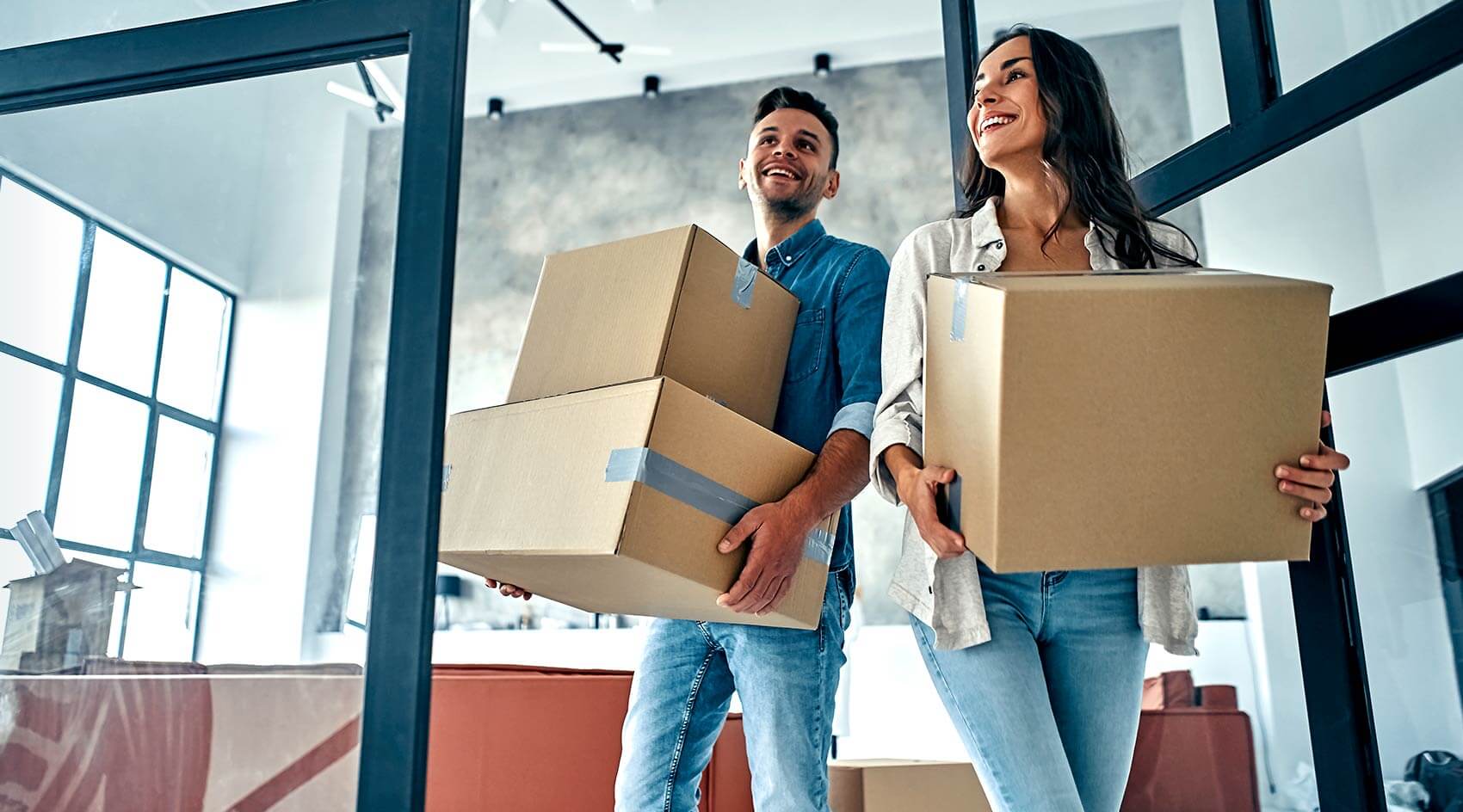 Couple carrying boxes into their new Cleveland house