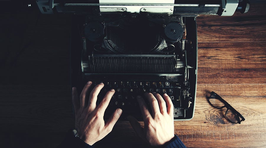 Author writing on a typewriter