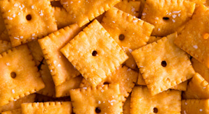 A pile of orange cheese cracker snacks.