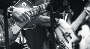 Two musicians playing electric guitars