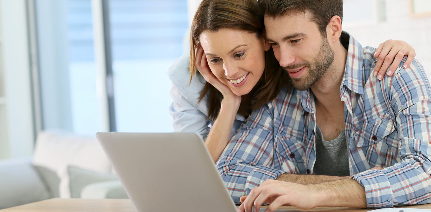 Man and woman looking at a computer