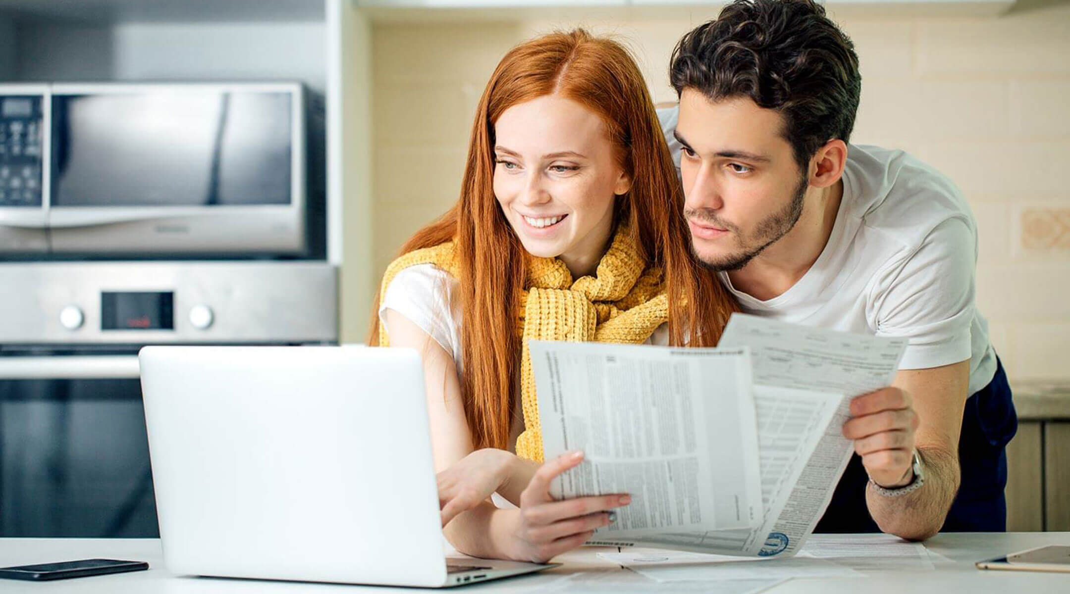 A couple reviews their electric bill online.