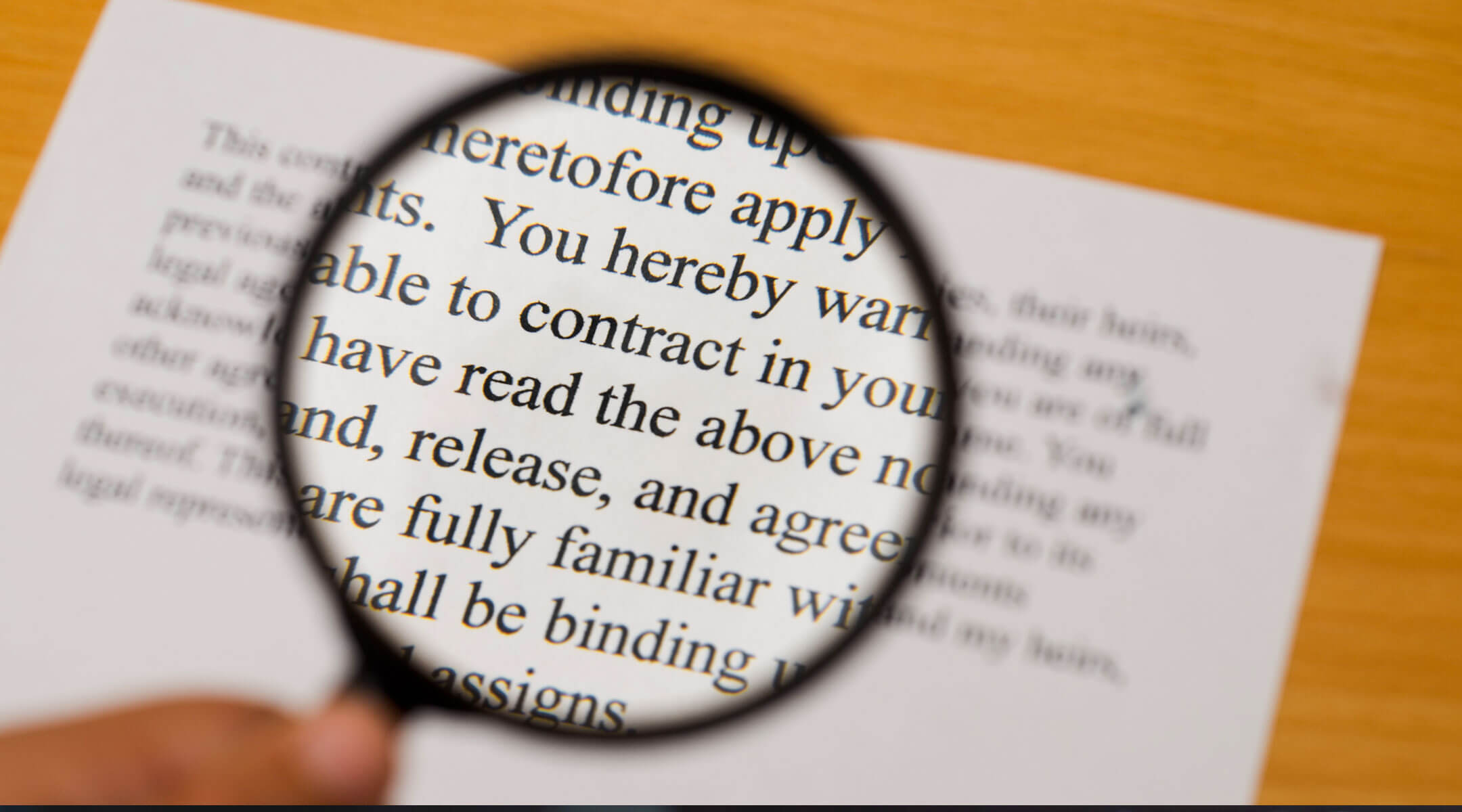 A magnifying glass looking at text.