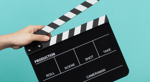 hand holding a film clapboard open