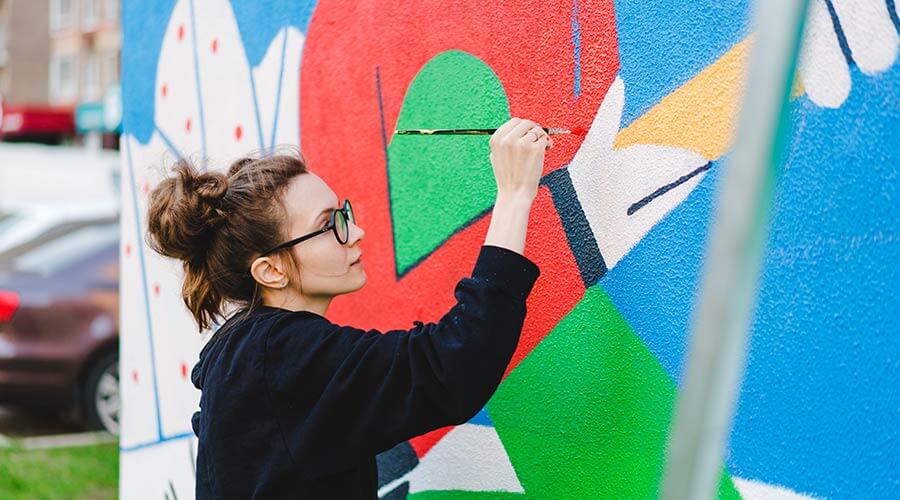 Person painting mural in