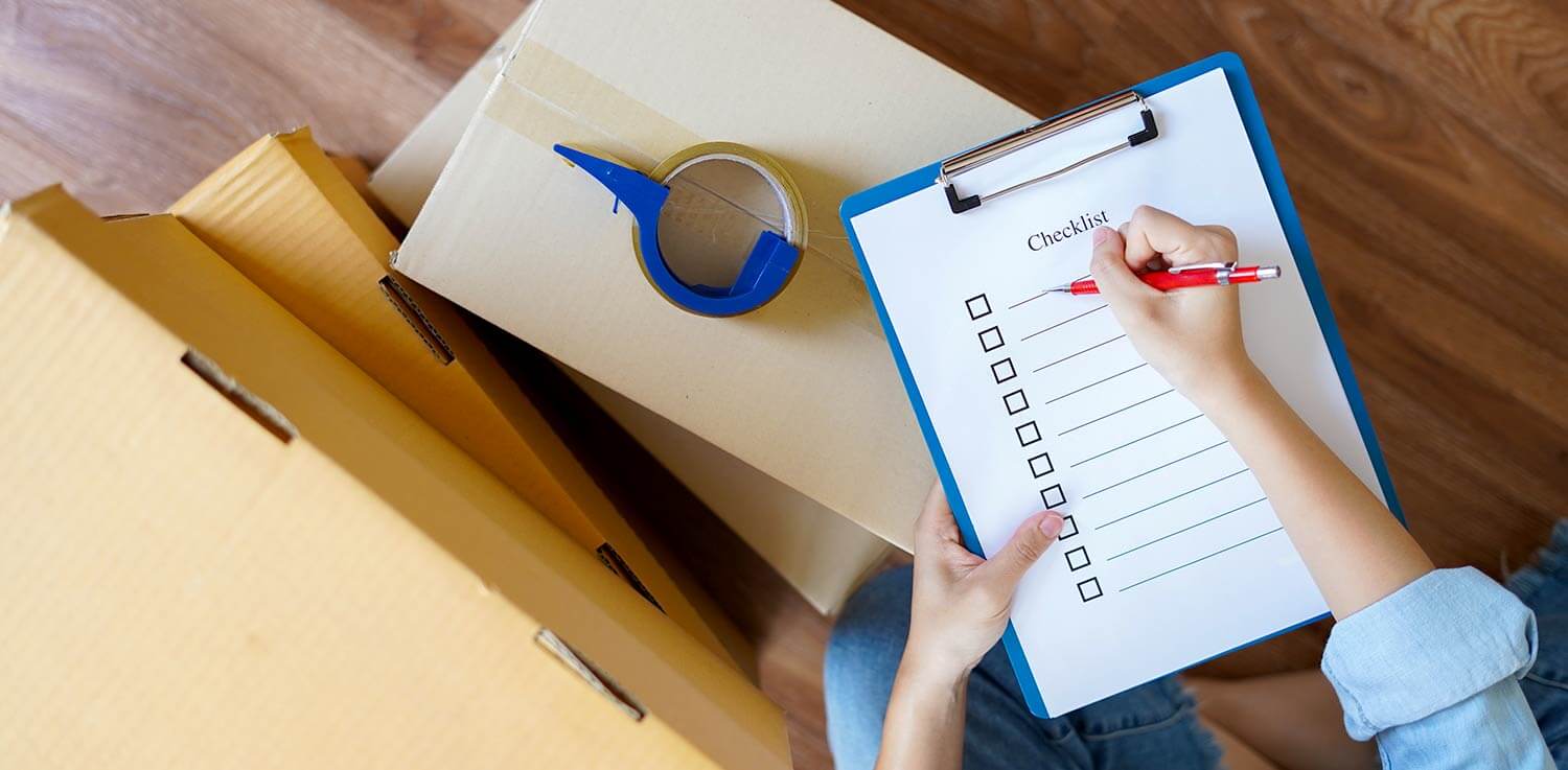 Person making moving checklist