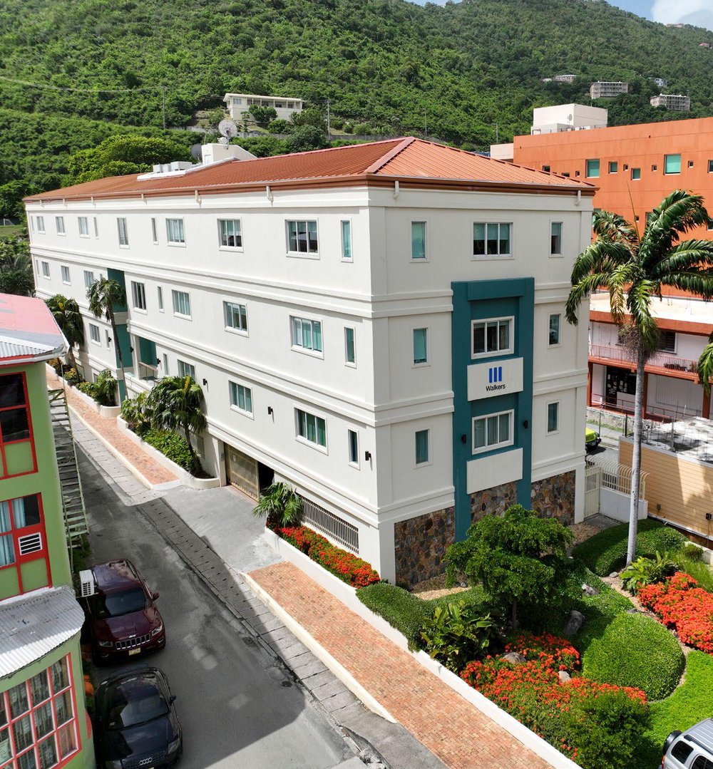 Exterior view of the Walkers office in the British Virgin Islands with a background of hilly terrain.