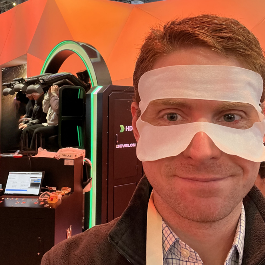 Chris Sweeney next to an immersive VR machine that simulates gravity and acceleration