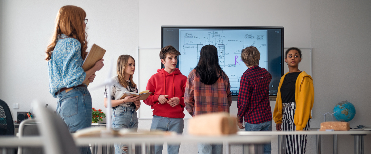 Group of students standing in a classroom