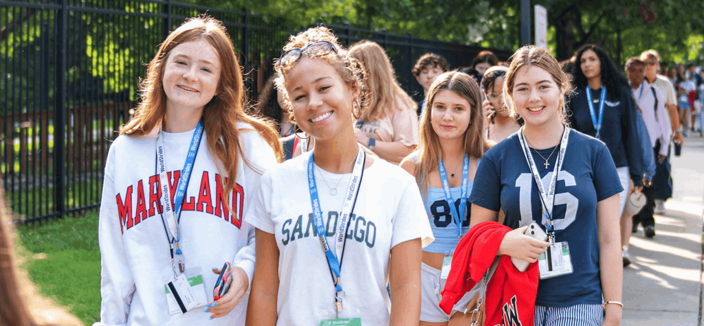 A group of students on a campus visit smiling
