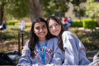Two students smiling
