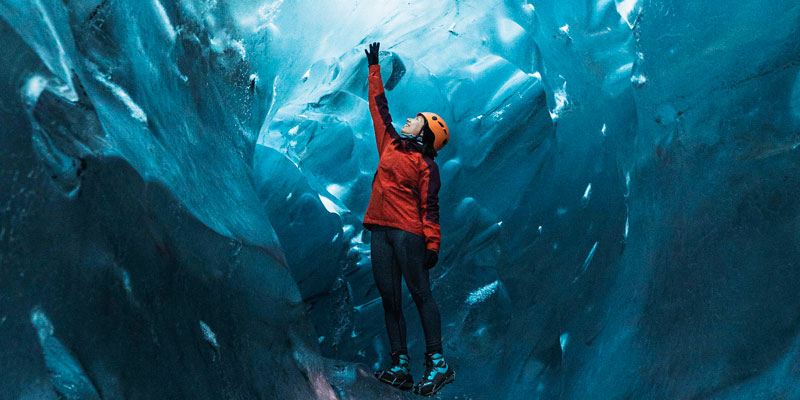 Person in red jacket in ice cave