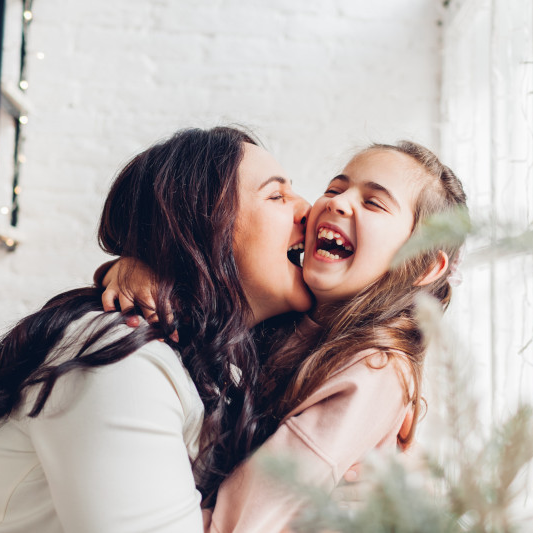mother-daughter-hugging-laughing