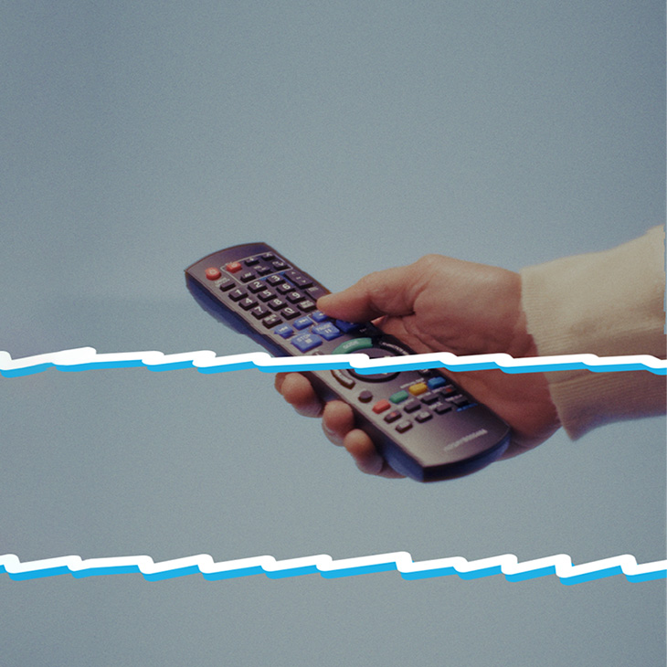 Hand holding remote control