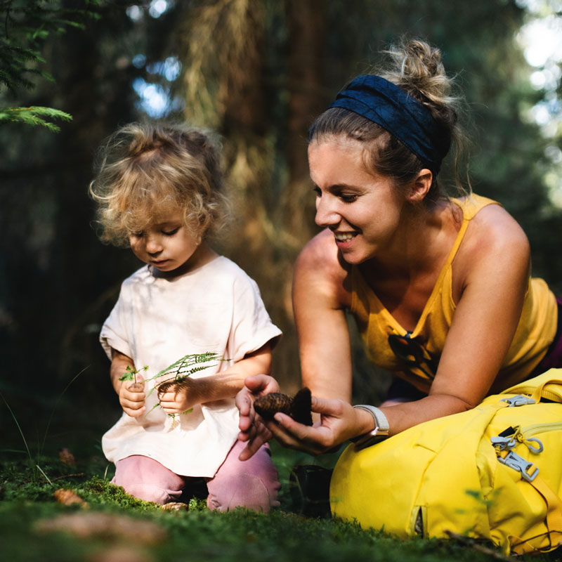 woman and toddler outdoors looking at nature