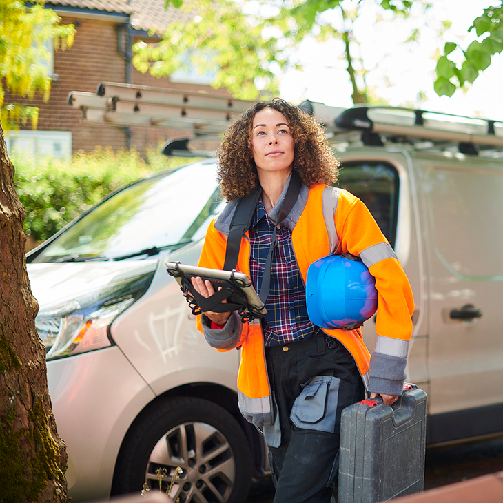 woman-with-toolbox-next-to-van