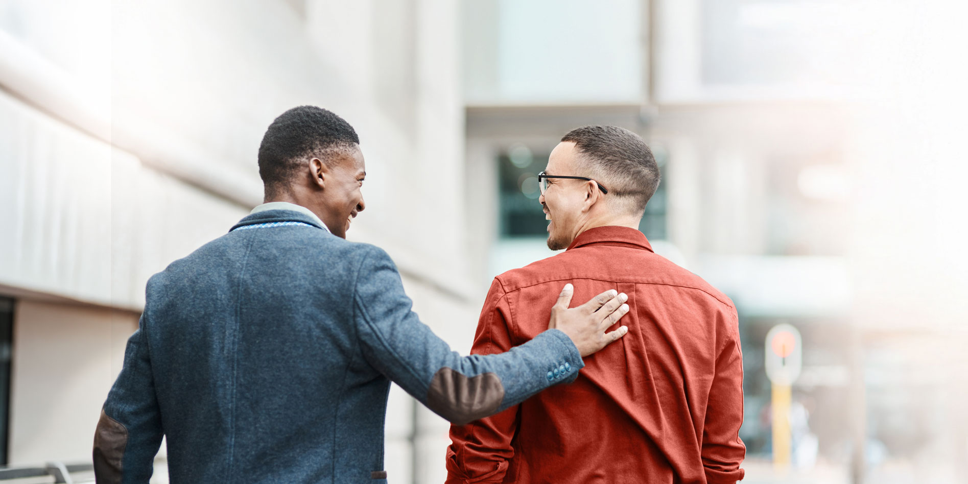 man patting friend on back