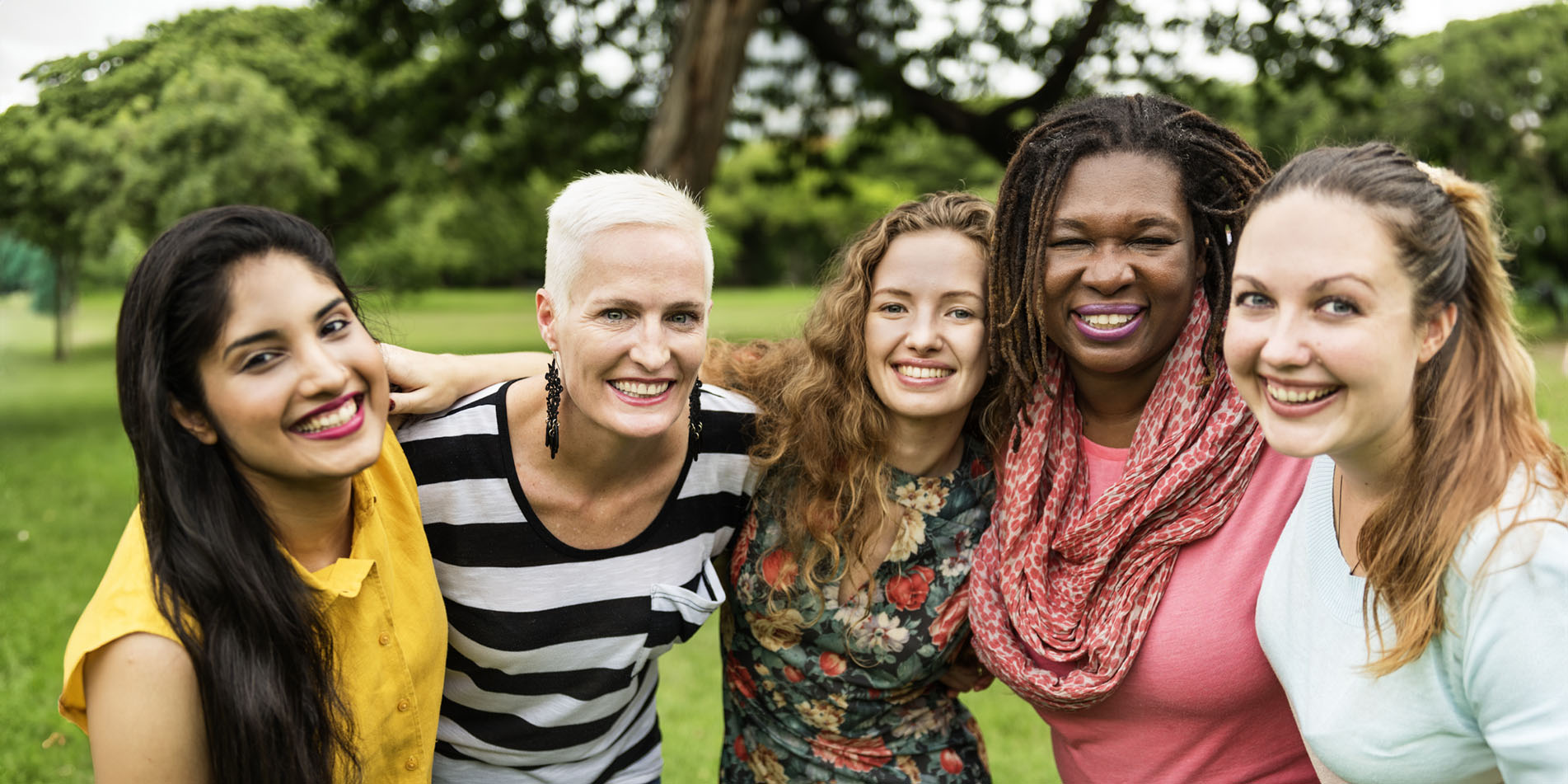 a-group-of-women-smiling-for-photo-in-park-526817902