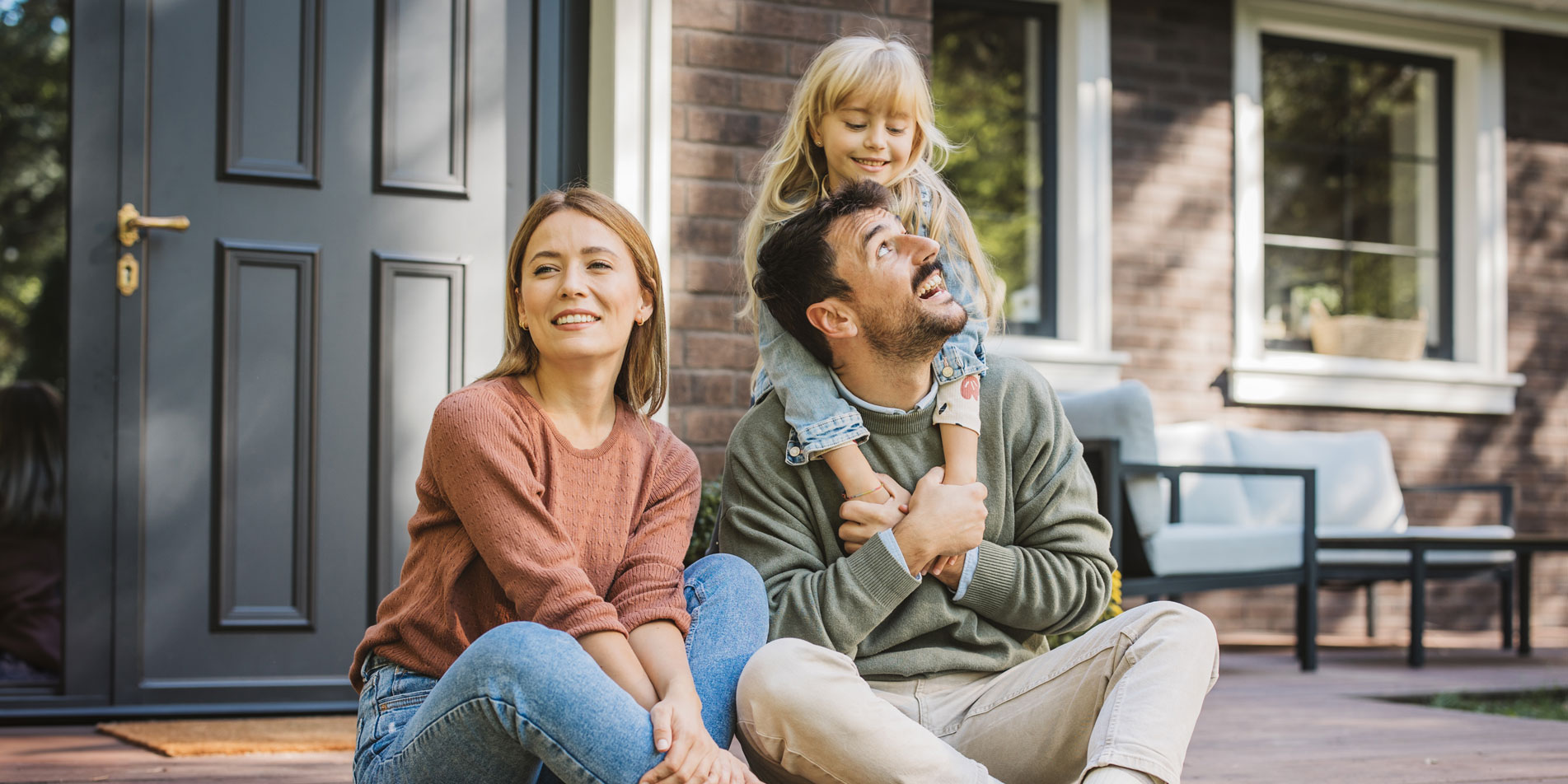 young family sitting outside