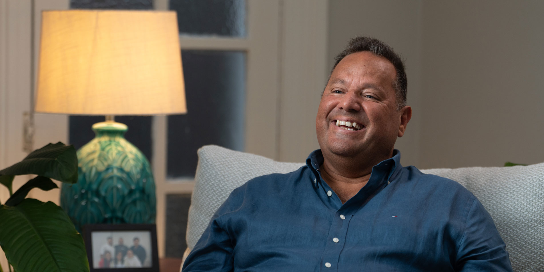 smiling man in blue shirt