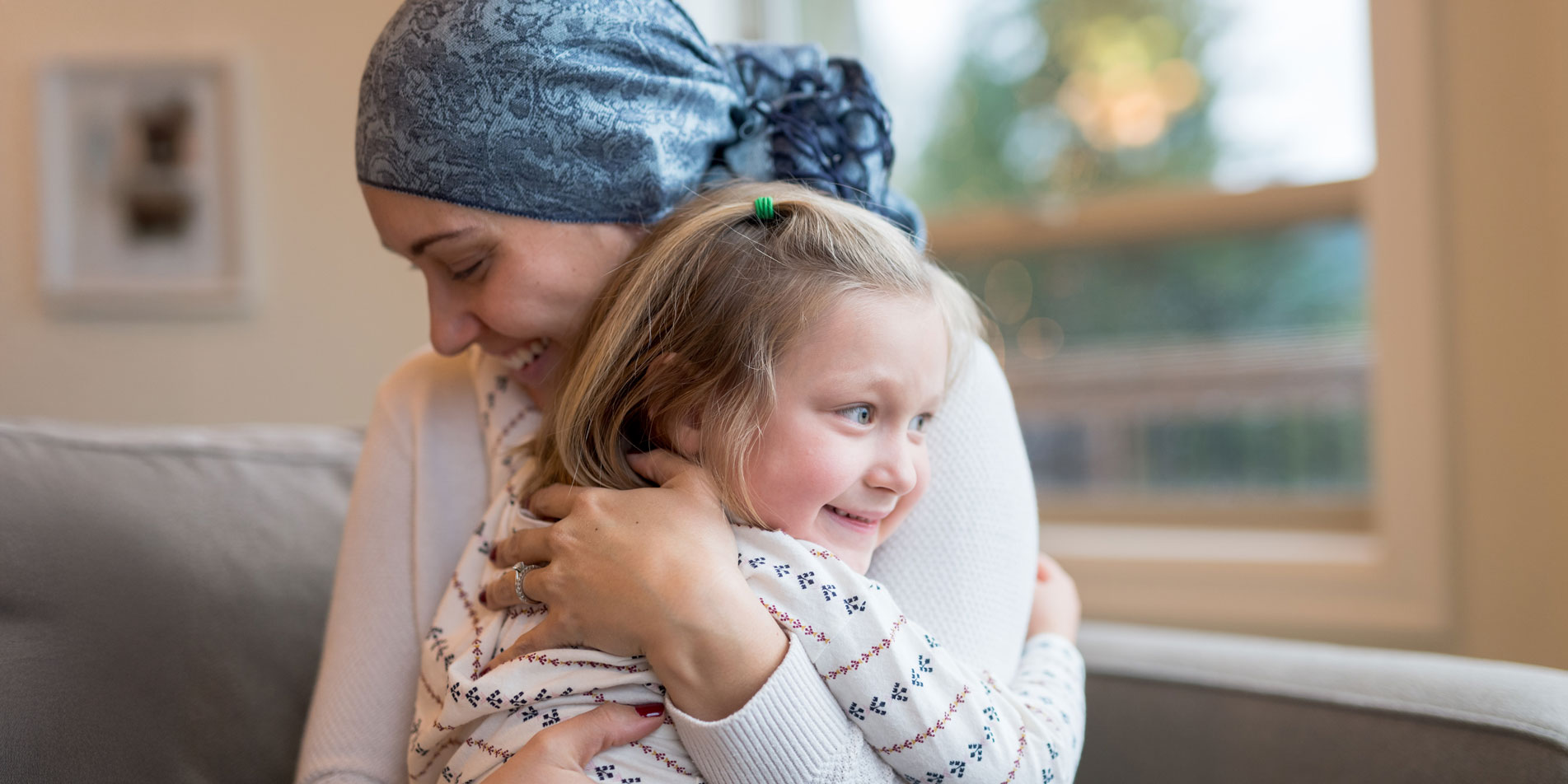 woman with head scarf hugging young girl