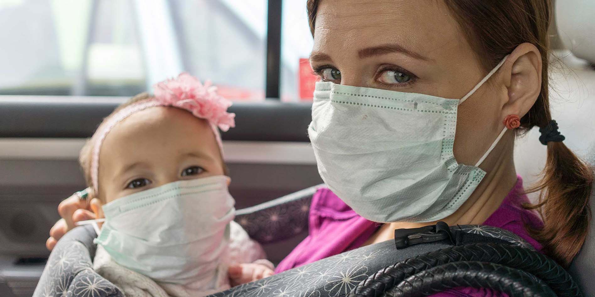 Woman and baby with face masks