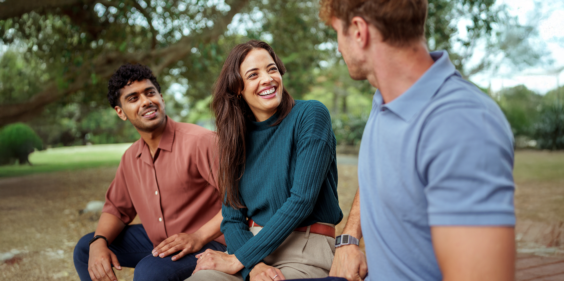 two-men-and-a-woman-chatting-under-tree