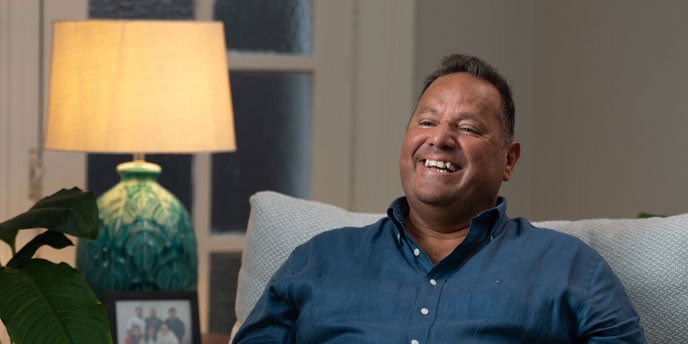 smiling man in blue shirt