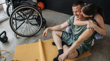 girlfriend helping to her boyfriend with rehabilitation exercises