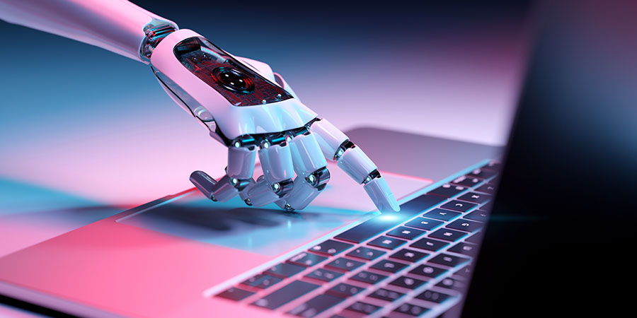 robot hand typing on laptop