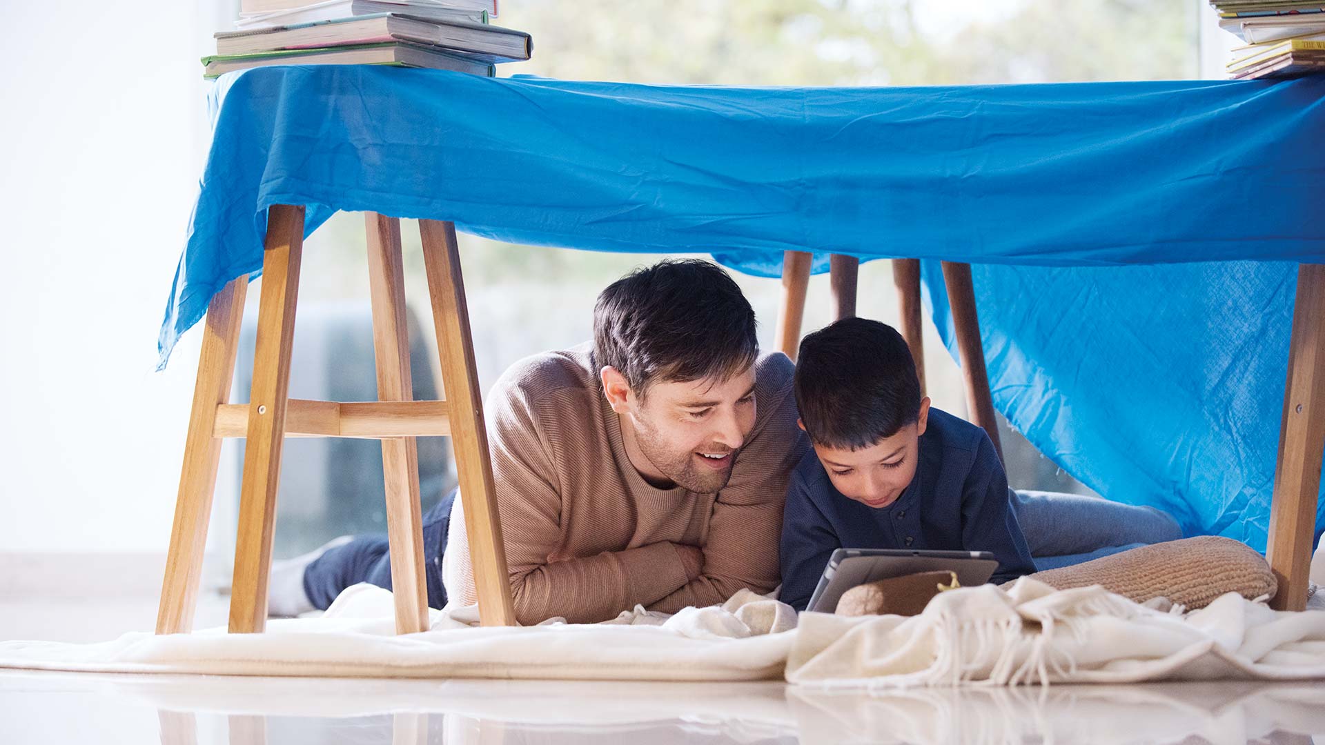 father and son looking at tablet