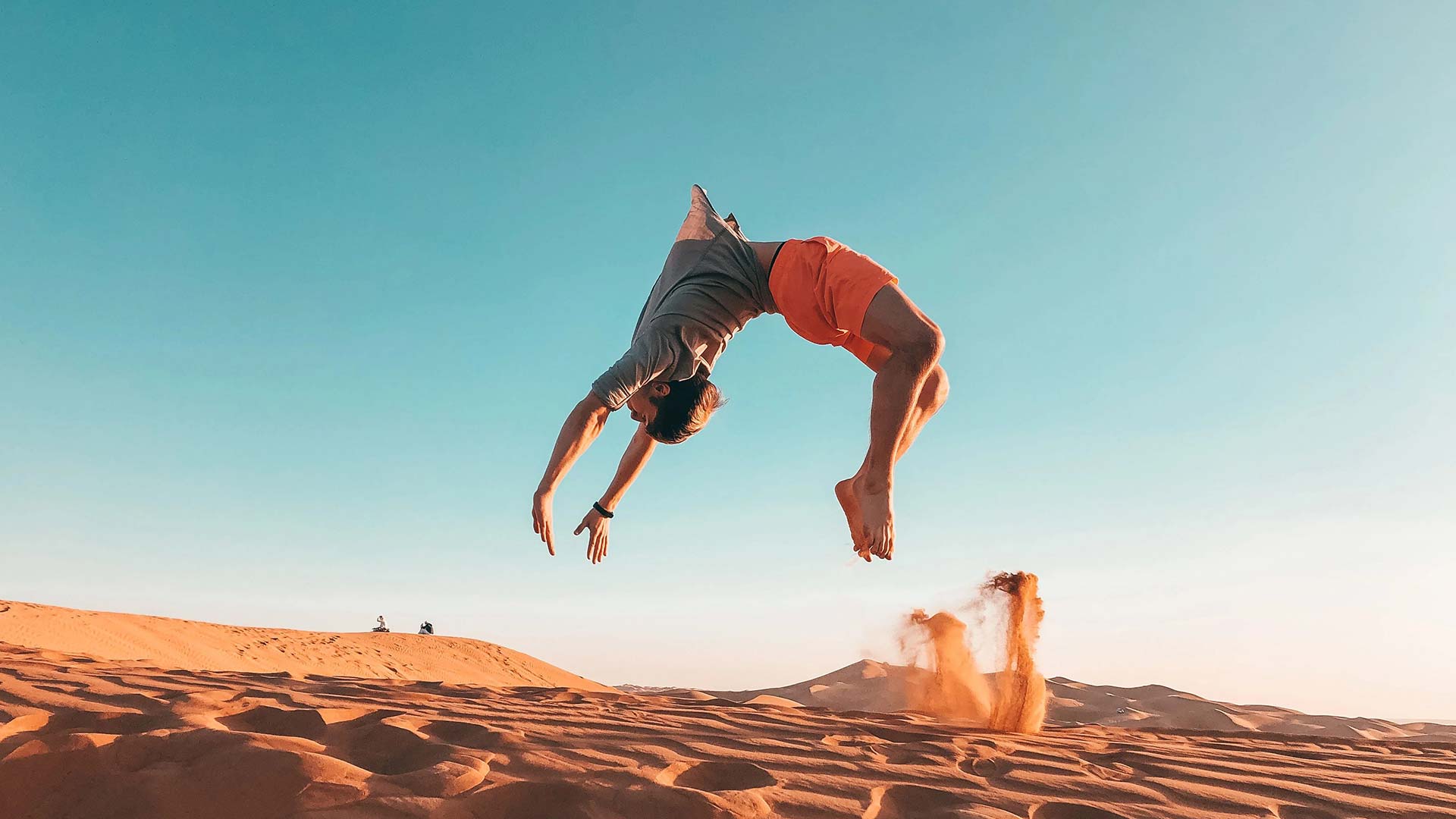 man doing a backflip in the desert
