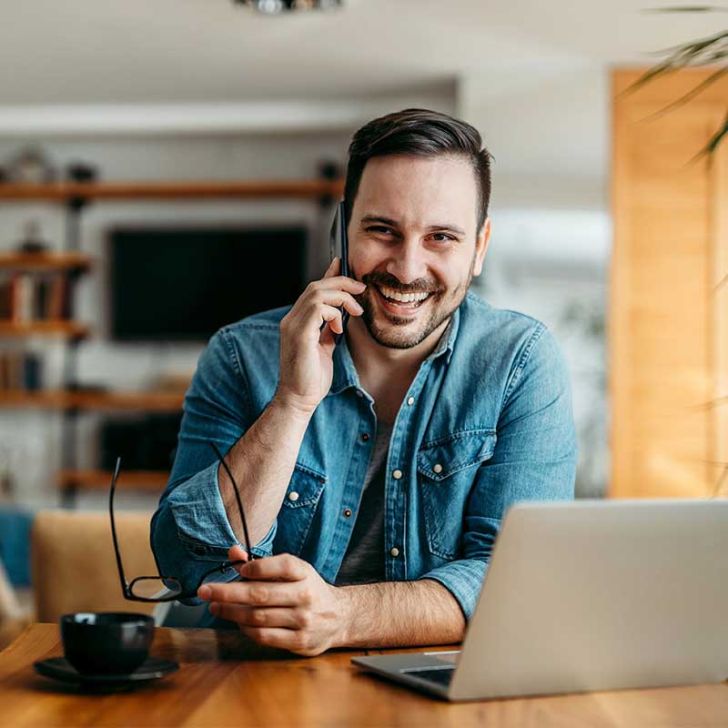 smiling man talking on the phone