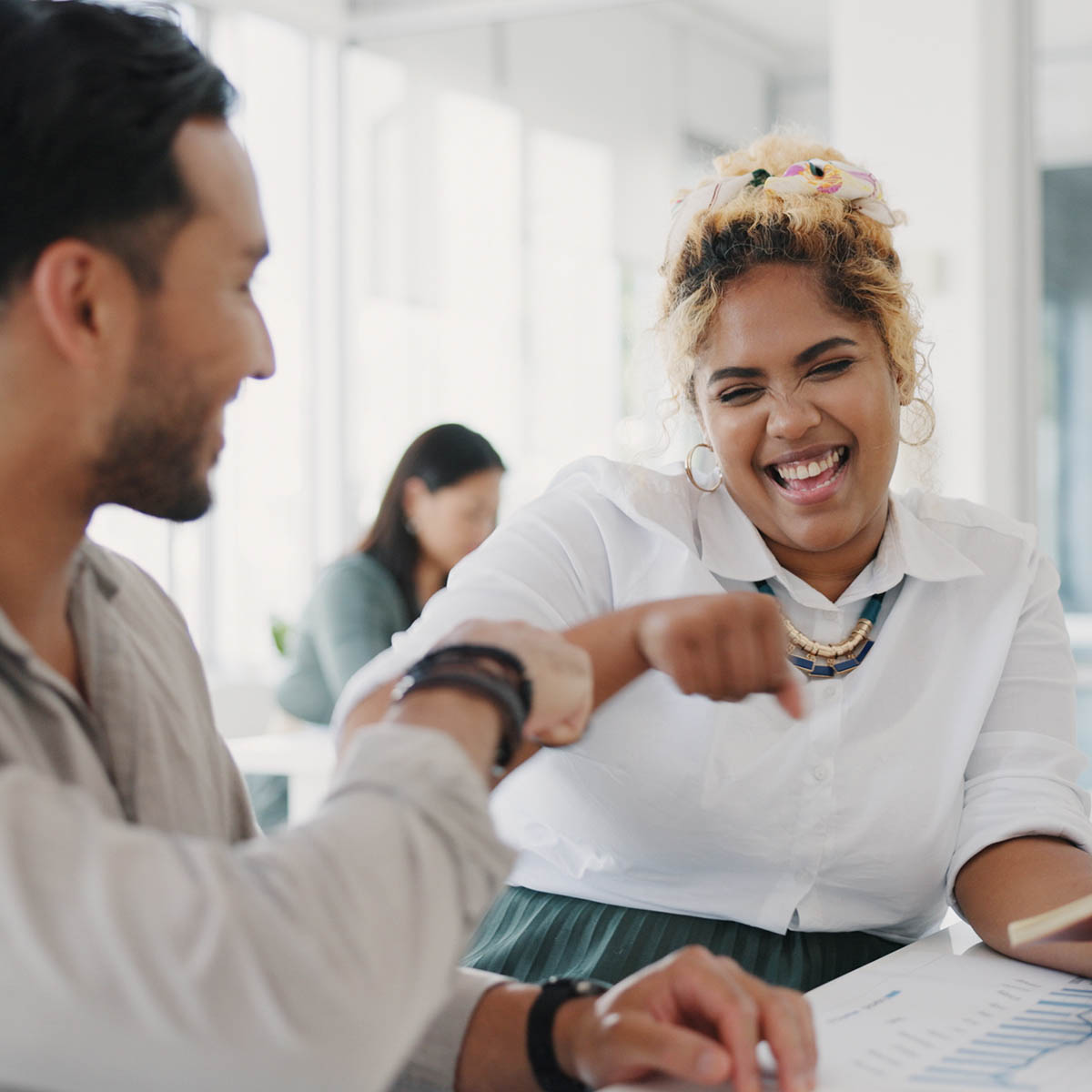happy employees fist bump in celebration