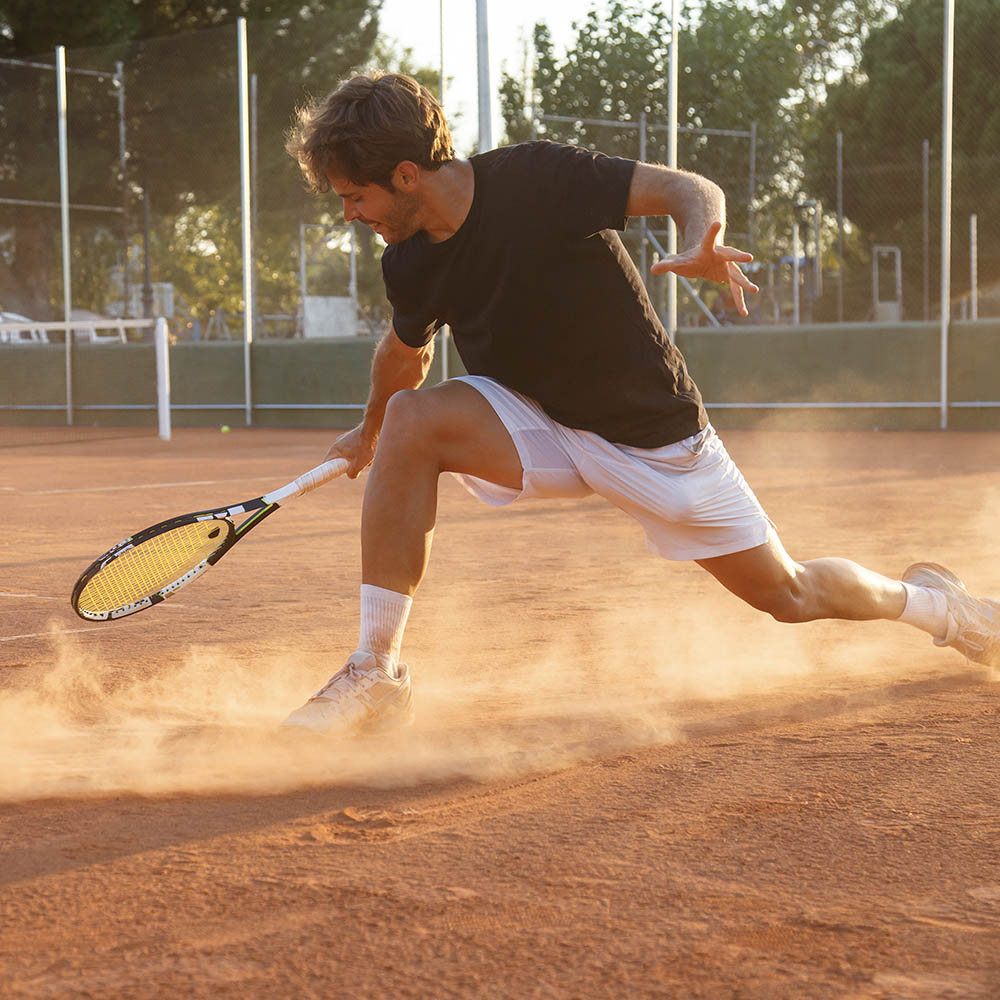 tennis player sliding through clay