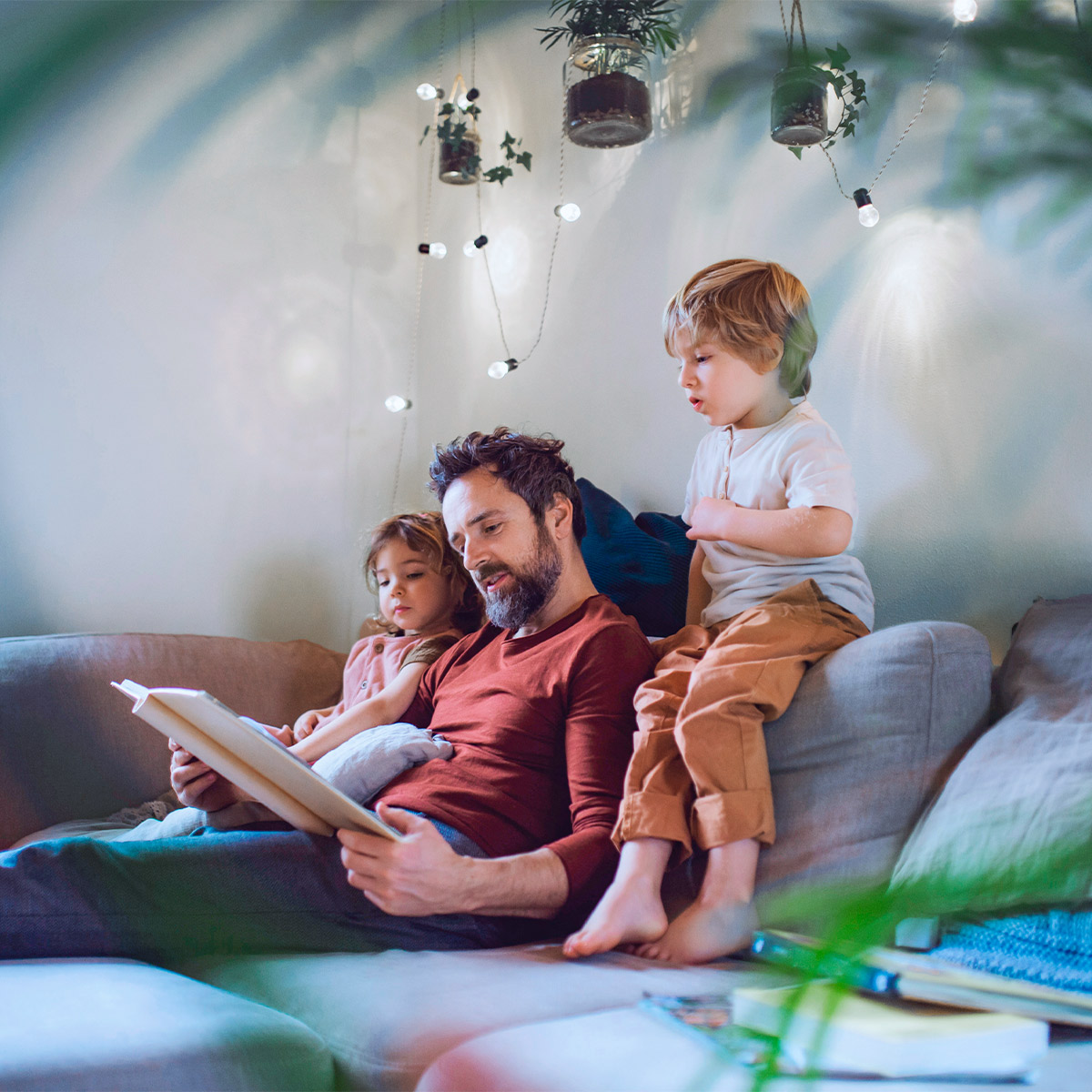 father reading a story to his children