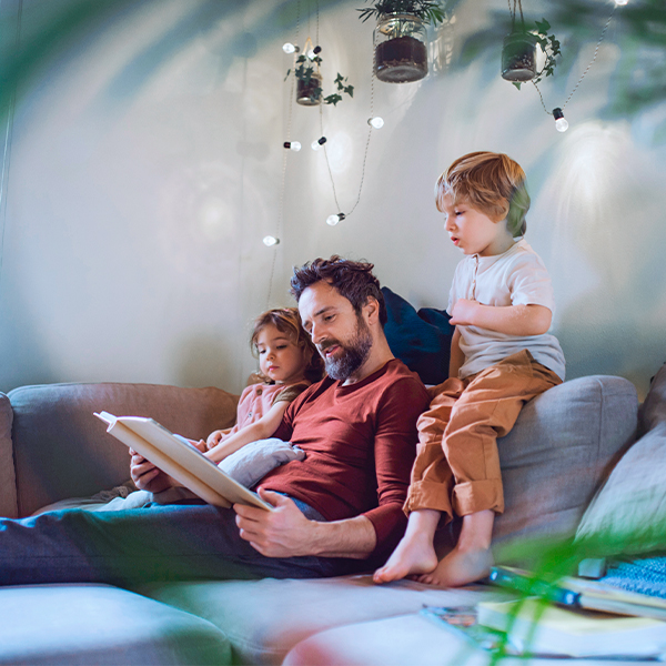 father reading a story to his children