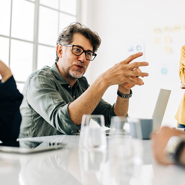 Business man explaining a project to his team