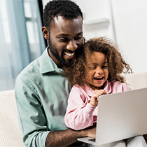 father and daughter looking at a computer