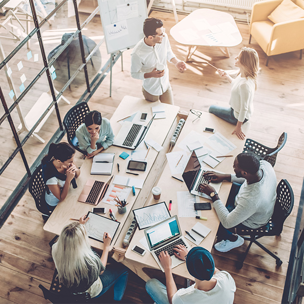 a group of people working together around a table