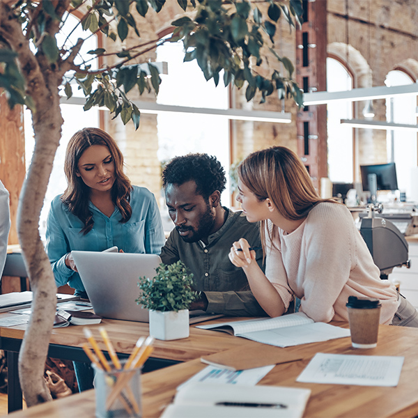 three people working together