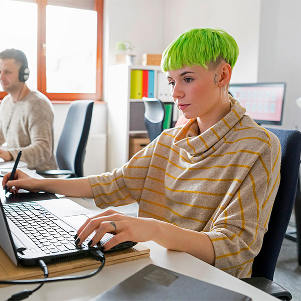 two people working their computers